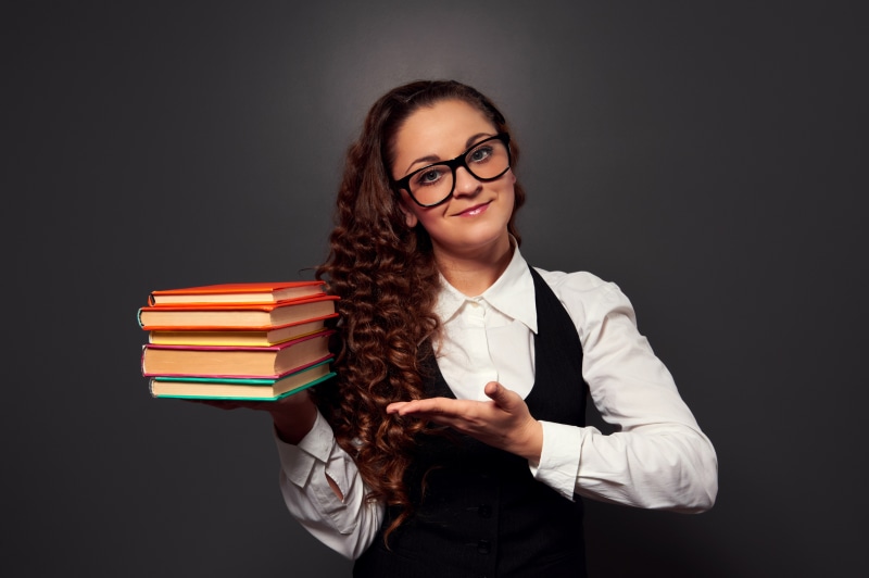 Woman with glasses holding books