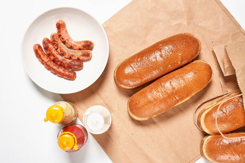 Hot dogs and buns with condiments