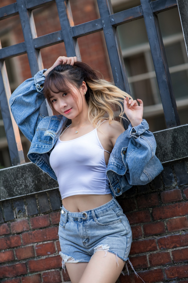 Asian woman in denim shorts and jacket