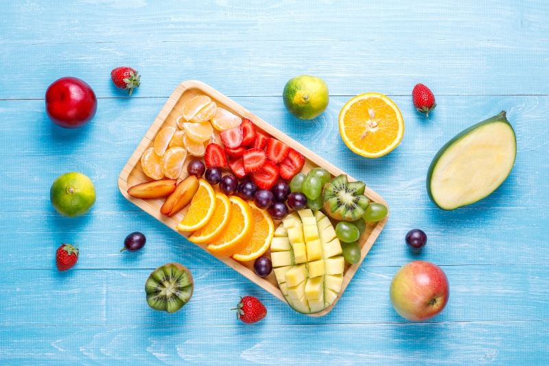 Assortment of Fresh Fruits on a Blue Wooden Table