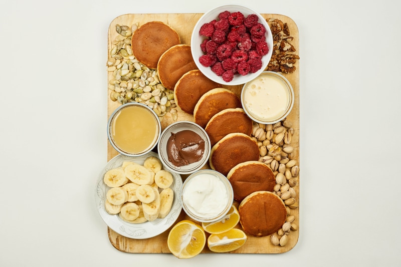 Pancake platter with fruits, nuts, and spreads