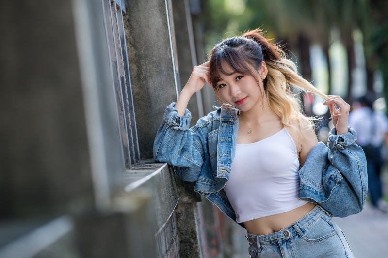 Asian woman in denim jacket and singlet