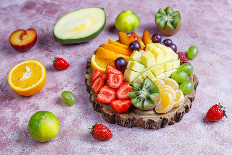 Fruit platter with strawberries, oranges, mango, kiwi, and grapes