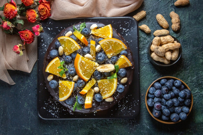 Chocolate cake with blueberries and orange slices