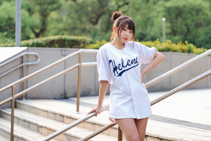 Asian girl in Helene baseball jersey on stairs