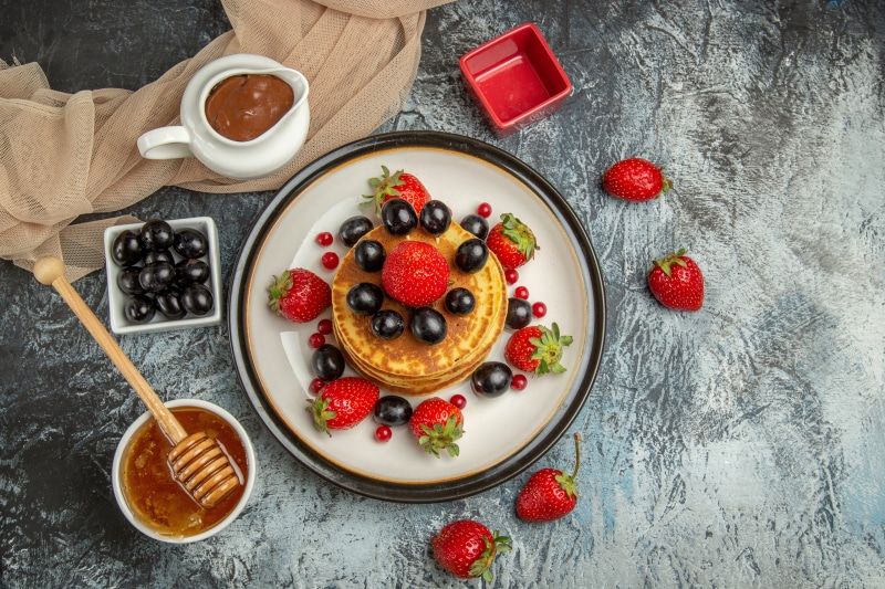 Pancakes with Strawberries, Grapes, Chocolate, and Honey