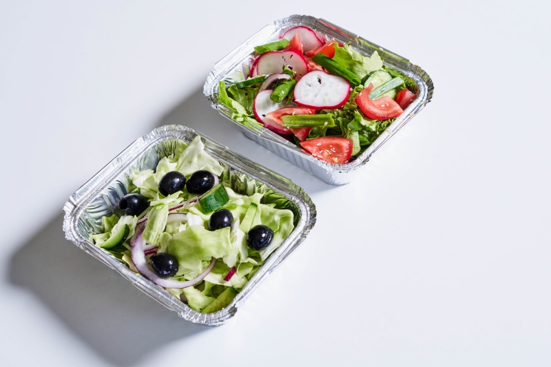 Two salads in aluminum containers