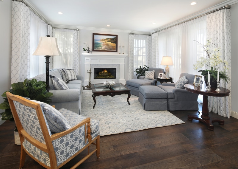 Living room with sofa, armchair, and fireplace