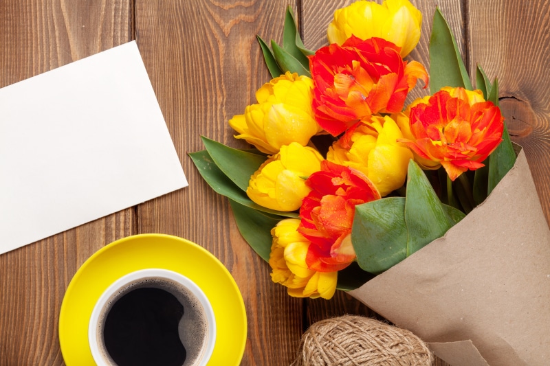 Tulips, Coffee, and a Greeting Card on Wood