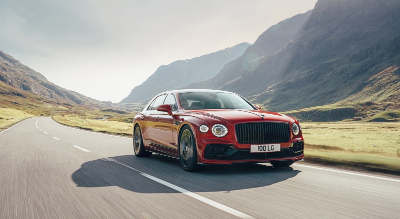 Red Bentley Flying Spur V8 on a mountain road