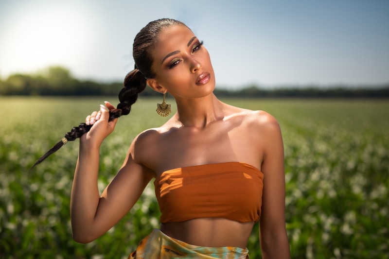 Brunette girl with braid hair in a field