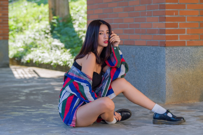 Asian woman sitting outdoors