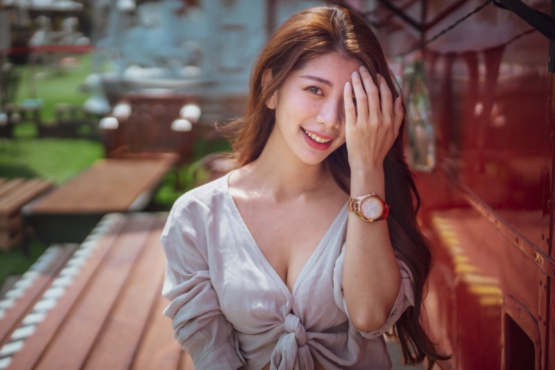 Asian woman with watch smiling