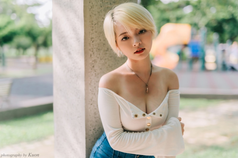 Blonde Asian girl in white top and jeans