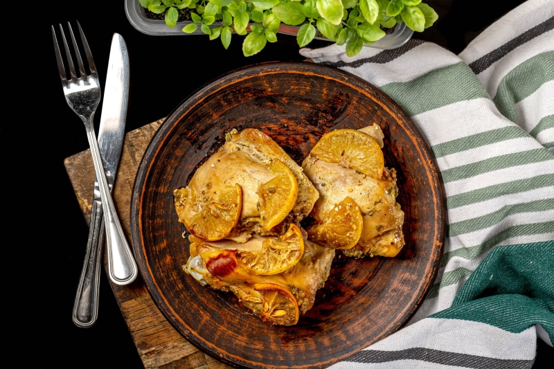 Roast Chicken with Lemon Slices on a Plate