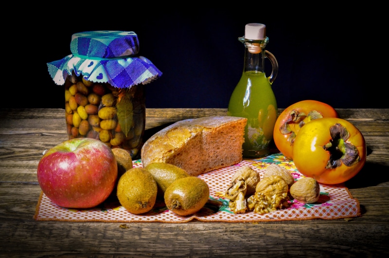 Still life with fruits, bread, olives, and oil