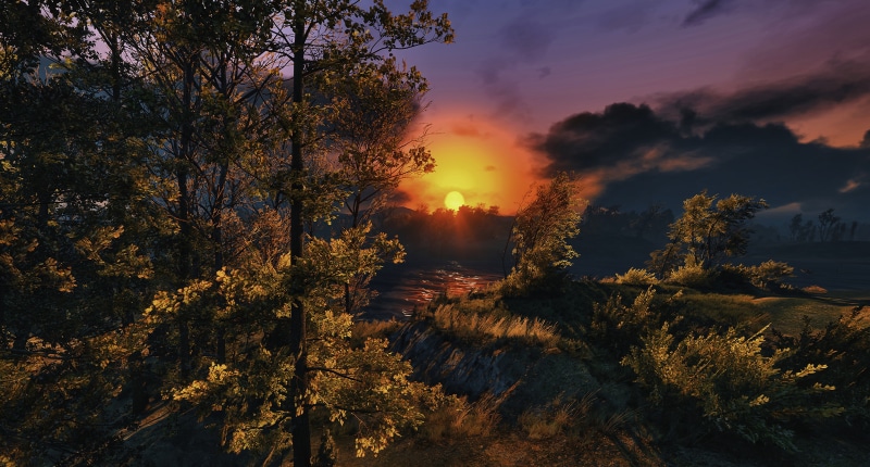 Sunset over a river with trees and clouds