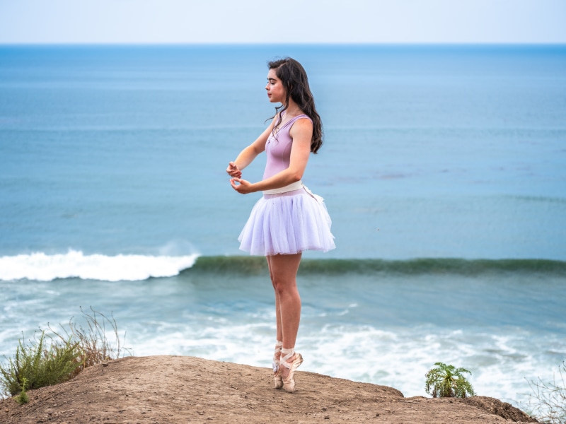 Ballet dancer on a cliff overlooking the ocean