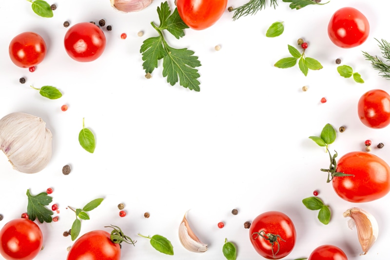 Tomatoes, Garlic, Herbs, and Spices on White Background