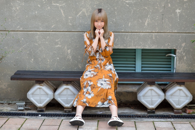 Asian girl sitting on a bench