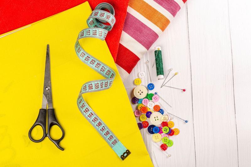Sewing Supplies: Scissors, Tape Measure, Buttons, Thread, and Fabric