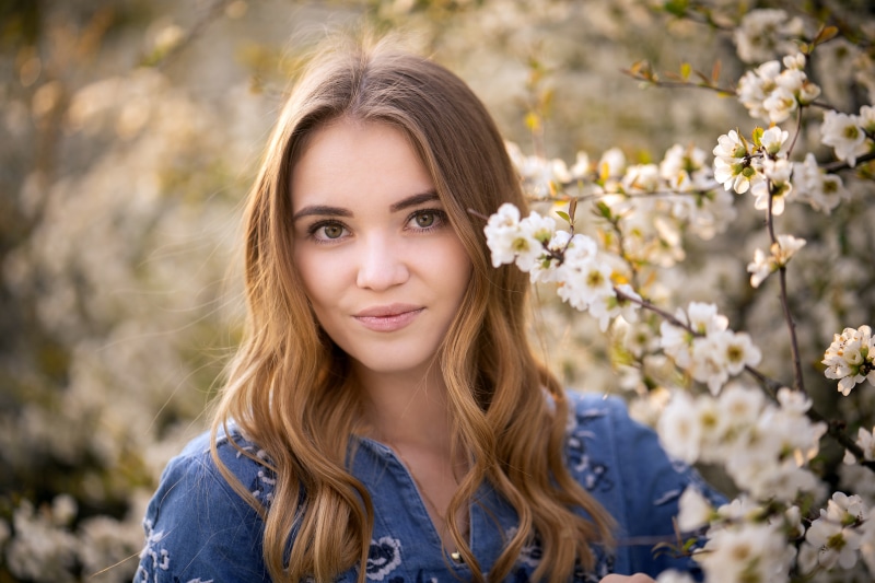Natalie with Dark Blonde Hair Among Flowering Trees