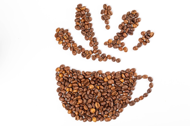 Coffee beans forming a cup with steam