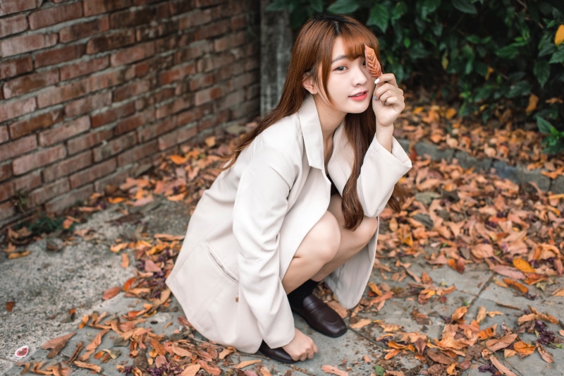 Asian woman in suit jacket with leaf
