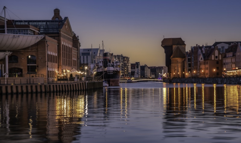 Gdansk, Poland waterfront at dusk with historic buildings and ships