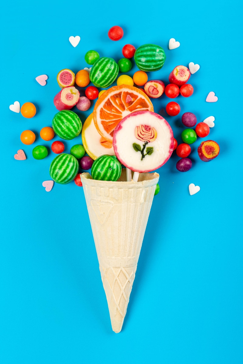 Ice cream cone filled with candies and lollipops
