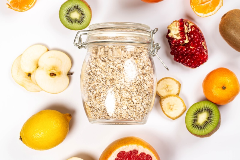 Jar of oatmeal surrounded by fruits