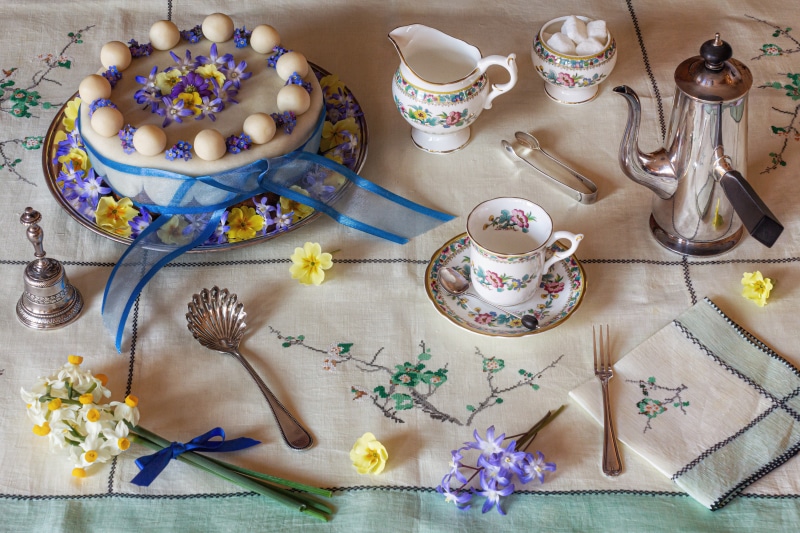 Still-life with cake, tea set, and flowers