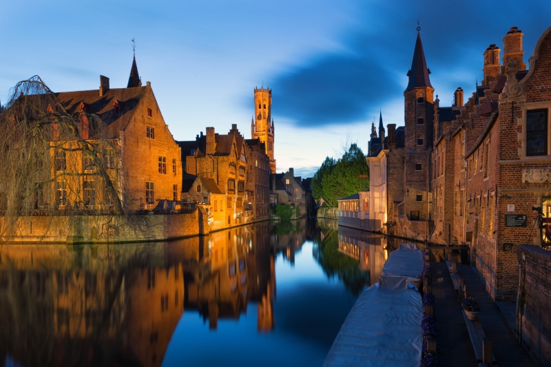 Bruges Canal with historic buildings and Belfry tower