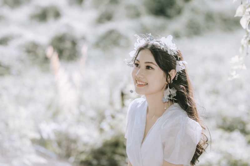 Asian woman with flower crown smiling