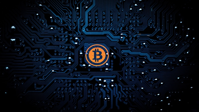Bitcoin symbol on a blue circuit board 4K