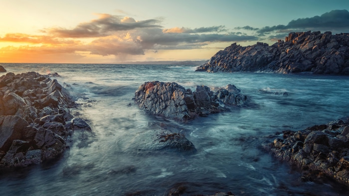 Rocky beach at sunset 4K