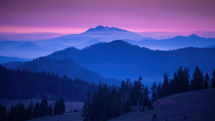 Mountain landscape with purple sky and blue hills