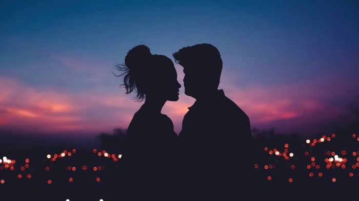Couple silhouette against a colorful sunset sky