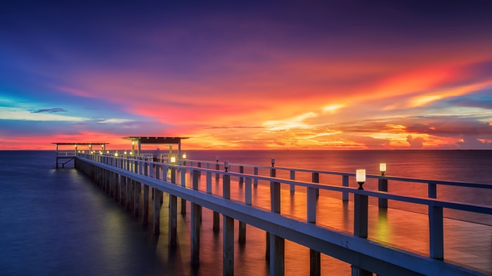 Pier over the ocean at sunset 4K