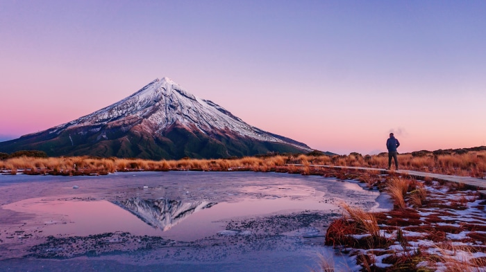 Mount Taranaki reflection in frozen lake at sunrise, New Zealand 4K