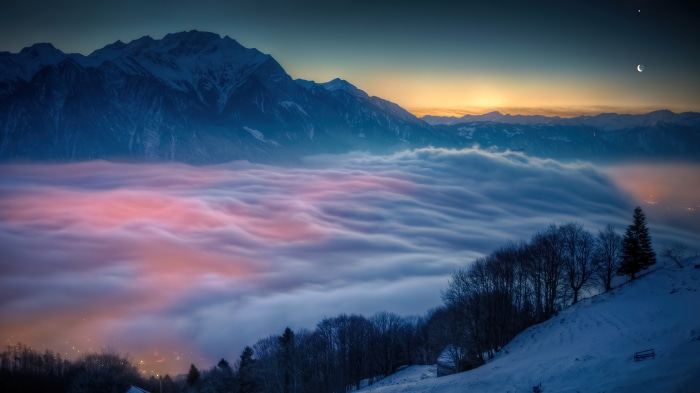 Mountain peak above clouds at sunrise 4K