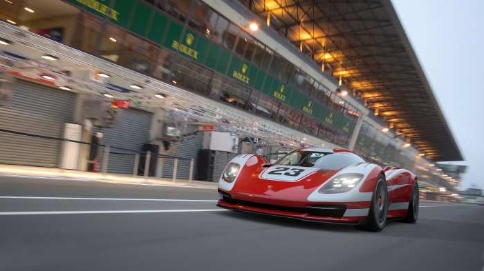 Red and white race car with number 23 on track
