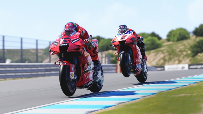 Two Ducati MotoGP 22 motorcycles racing on a track