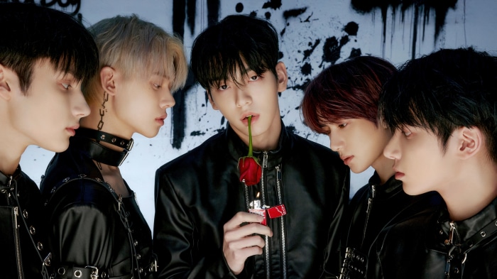Tomorrow X Together (TXT) members with rose and lighter