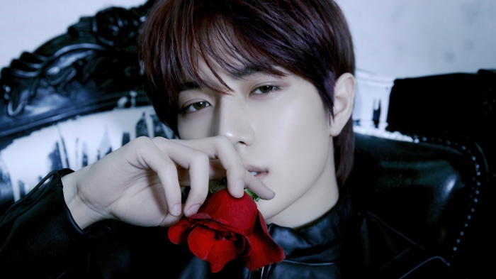 Beomgyu from Tomorrow X Together holding a red rose