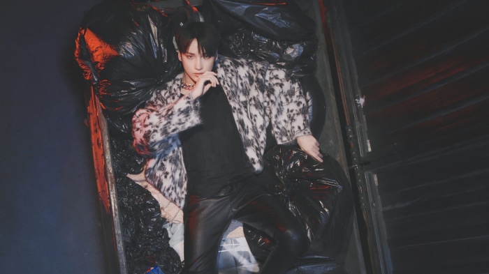 Hueningkai from Tomorrow X Together in trash bags