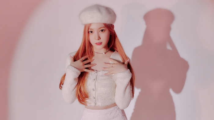 Chaehyun from Kep1er wearing a white beret and fluffy cardigan