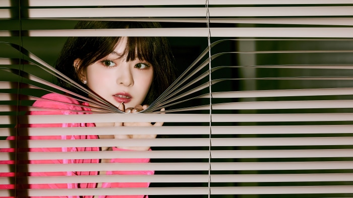 Nagyung from fromis_9 peeking through blinds