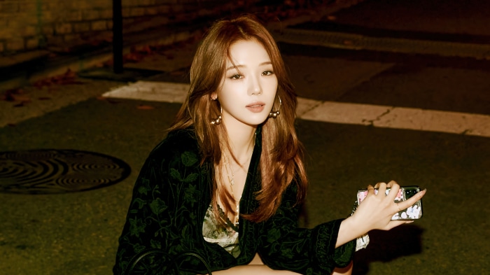 Jisun from fromis_9 holding a phone