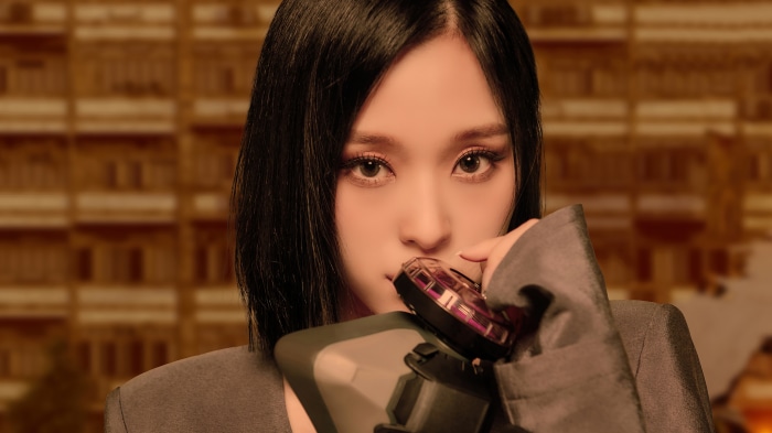 Gahyeon from Dreamcatcher holding a device